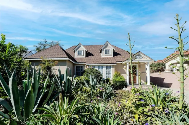a front view of a house with a garden