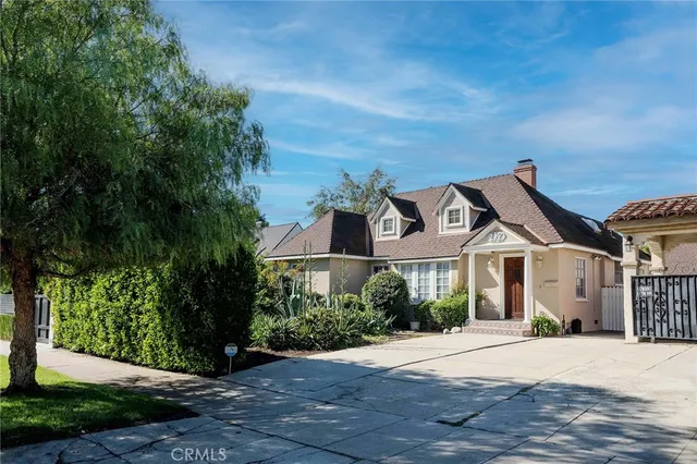a front view of a house with a yard and a garage