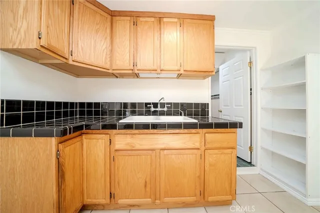 a view of a sink and cabinet with wooden floor