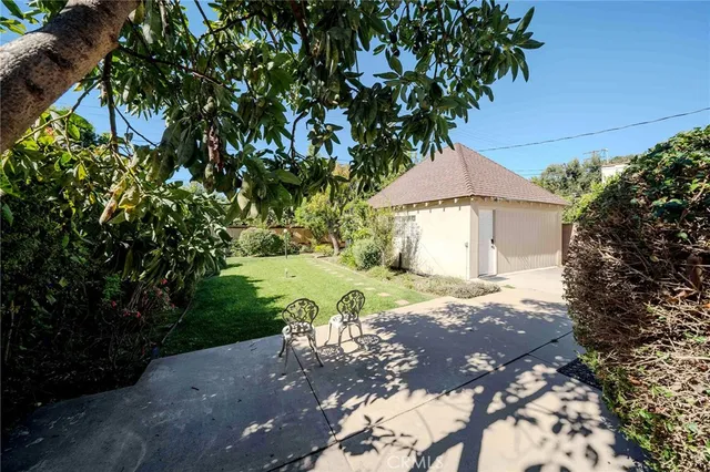 a view of a house with a yard and tree