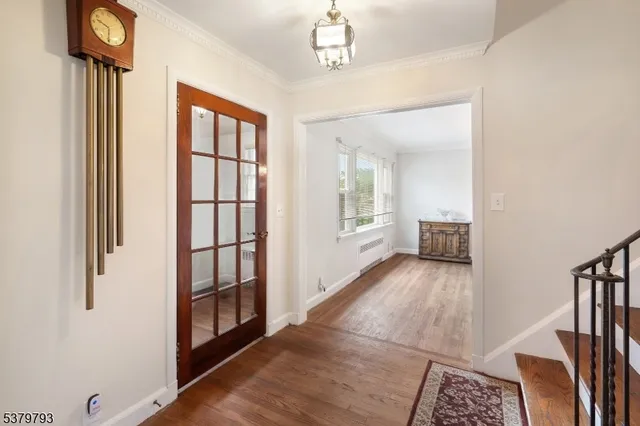 a view of a hallway with wooden floor and staircase