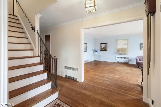 a view of a room with wooden floor and stairs