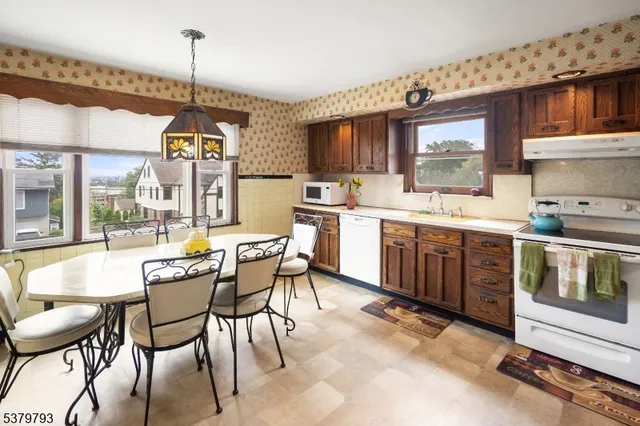 a large kitchen with a table and chairs