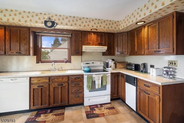 a kitchen with a sink stove and cabinets