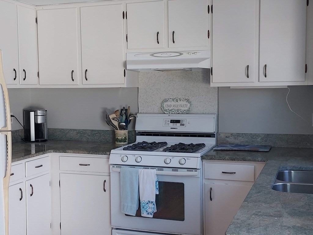 41 Dunstable Cross Road South Dennis, MA 02660 - Photo 8 of 38 a kitchen with white cabinets and appliances