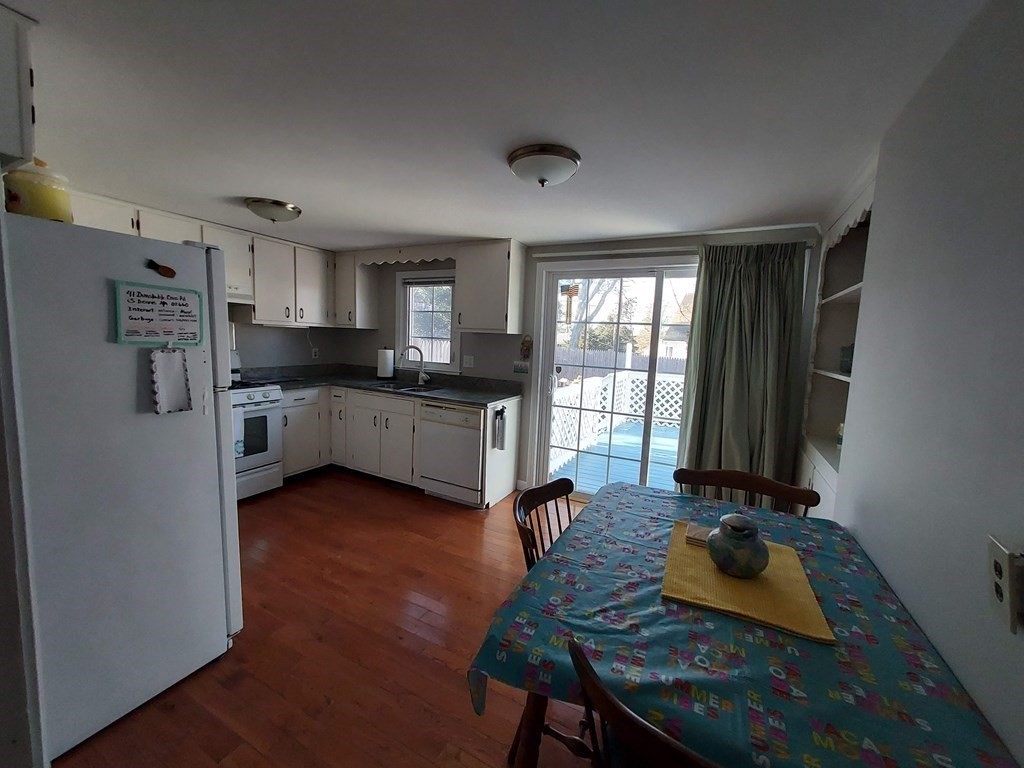 41 Dunstable Cross Road South Dennis, MA 02660 - Photo 10 of 38 a kitchen with a refrigerator and a stove top oven