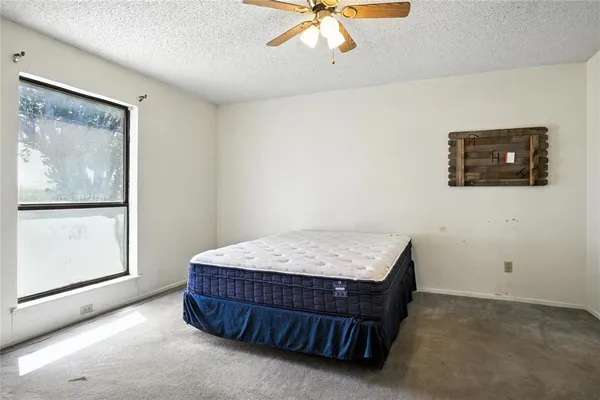 a bedroom with a bed and window
