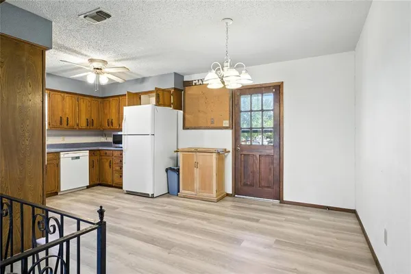 a view of a kitchen with refrigerator and microwave
