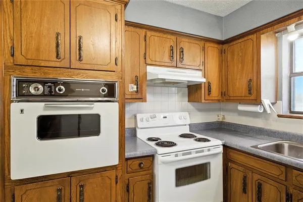 a kitchen with a stove and a sink