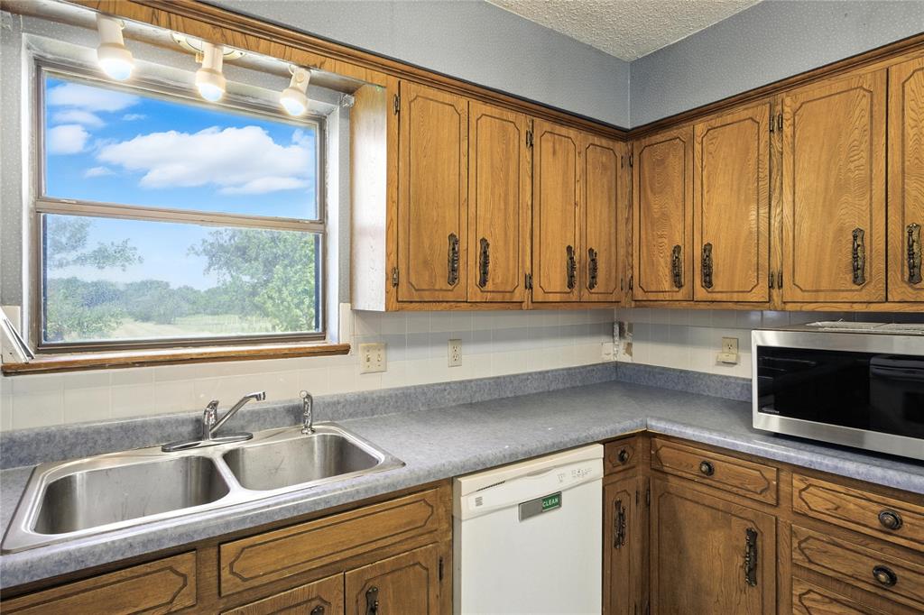 105 Greenhill Lane Cooper, TX 75432 - Photo 8 of 31 a kitchen with a sink and large window
