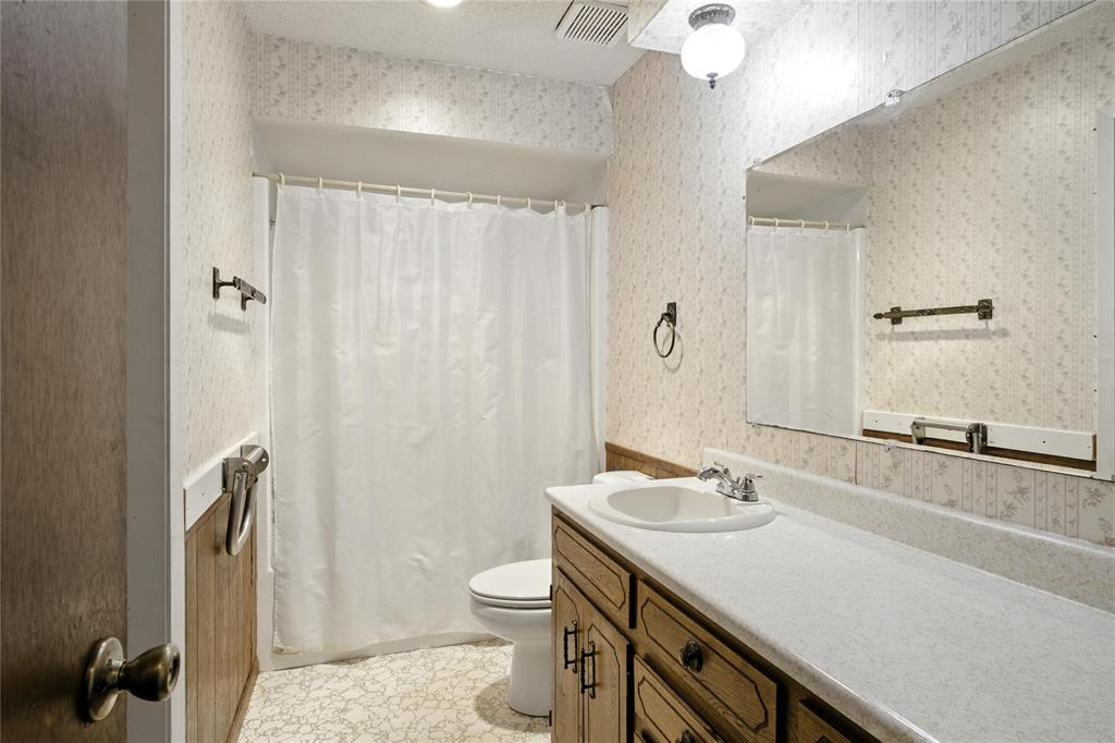 105 Greenhill Lane Cooper, TX 75432 - Photo 10 of 31 a bathroom with a sink a toilet a mirror and shower