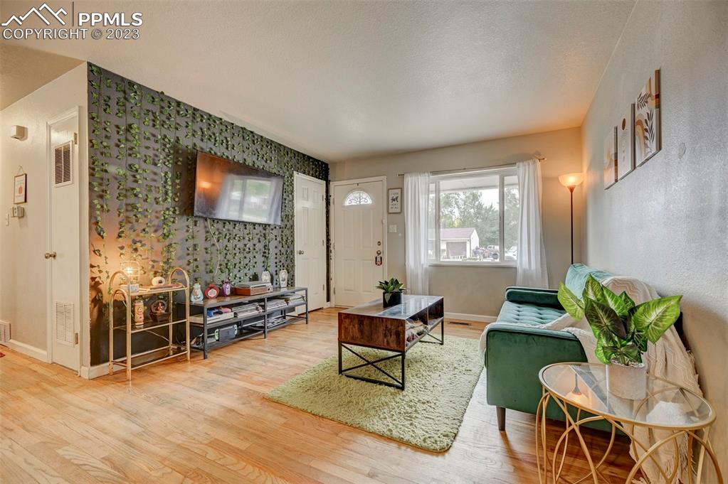 113 Kiva Road Colorado Springs, CO 80911 - Photo 2 of 12 a living room with furniture and a flat screen tv
