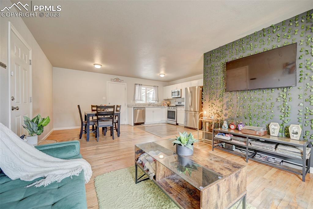 113 Kiva Road Colorado Springs, CO 80911 - Photo 4 of 12 a living room with fireplace furniture and a flat screen tv
