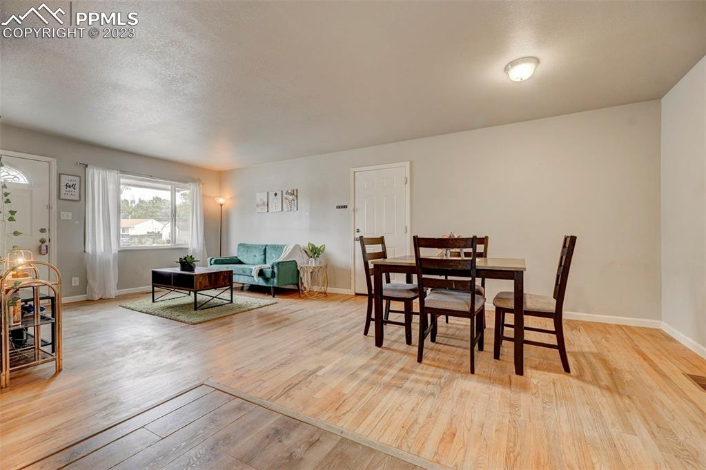113 Kiva Road Colorado Springs, CO 80911 - Photo 7 of 12 a dining room with furniture and wooden floor