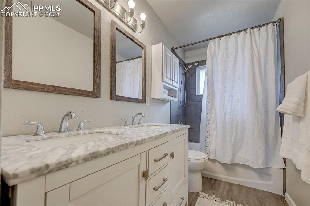 113 Kiva Road Colorado Springs, CO 80911 - Photo 8 of 12 a bathroom with a granite countertop sink toilet and shower