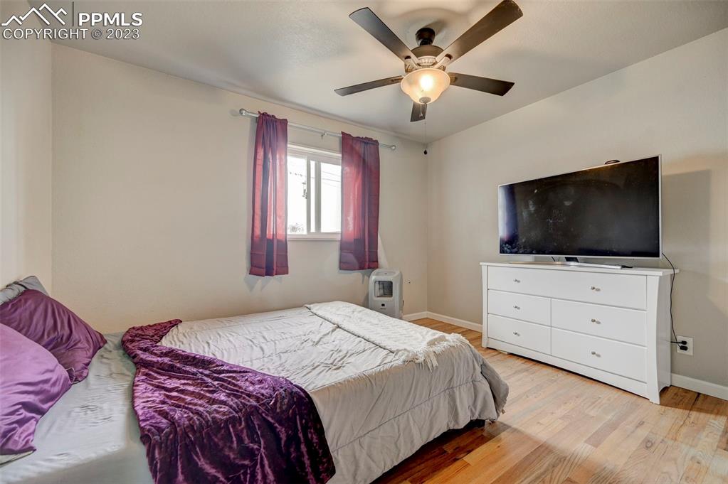 113 Kiva Road Colorado Springs, CO 80911 - Photo 10 of 12 a bedroom with a large bed and a flat screen tv