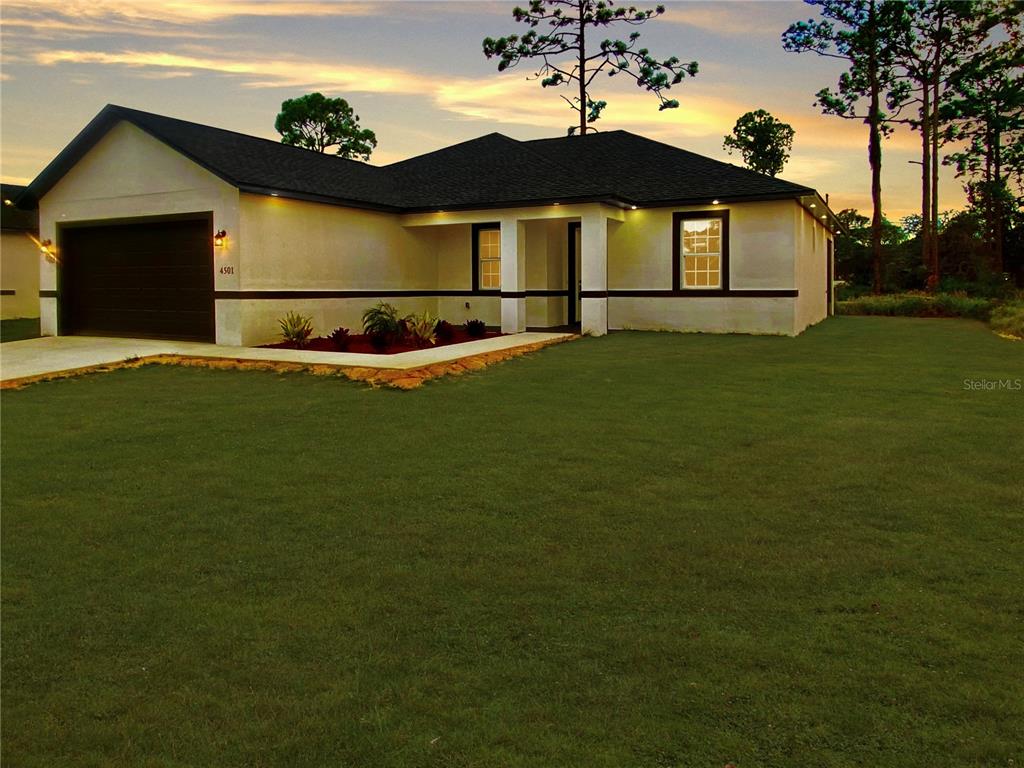 a front view of a house with a garden