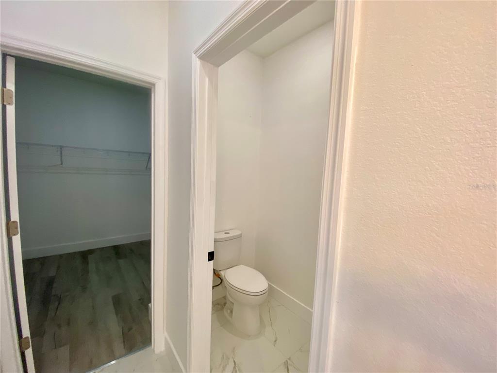 4501 Schumacher Road Sebring, FL 33872 - Photo 21 of 31 a bathroom with a granite countertop sink and a toilet