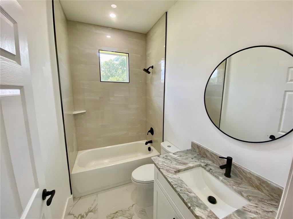4501 Schumacher Road Sebring, FL 33872 - Photo 26 of 31 a bathroom with a granite countertop sink toilet and shower