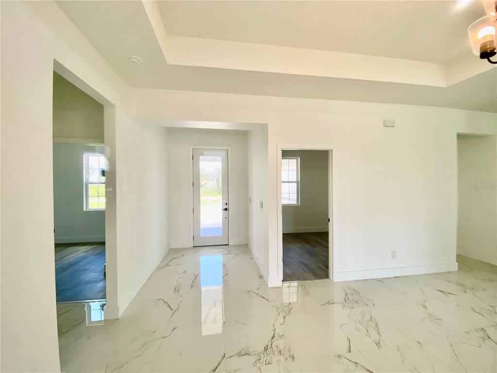 4501 Schumacher Road Sebring, FL 33872 - Photo 4 of 31 a view of a hallway with wooden shelves