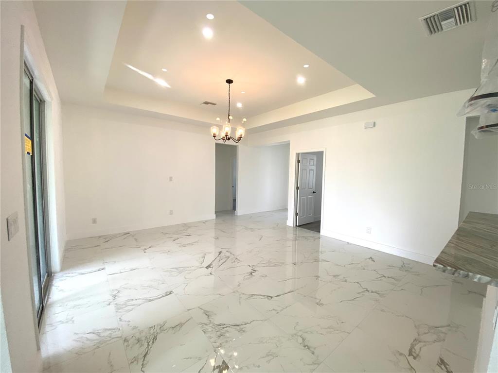 4501 Schumacher Road Sebring, FL 33872 - Photo 5 of 31 a view of a hallway with a chandelier