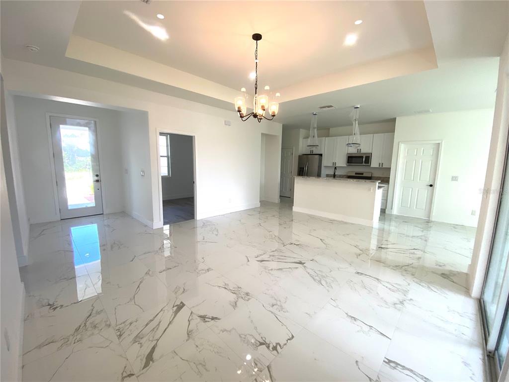 4501 Schumacher Road Sebring, FL 33872 - Photo 6 of 31 a view of a hallway with granite countertop a couch and a chandelier