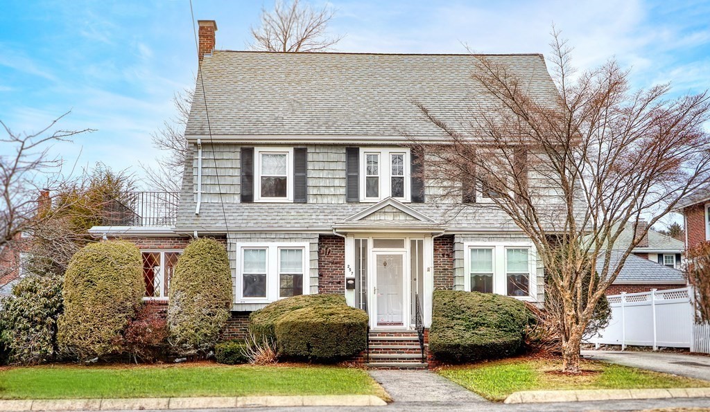 a front view of a house with garden