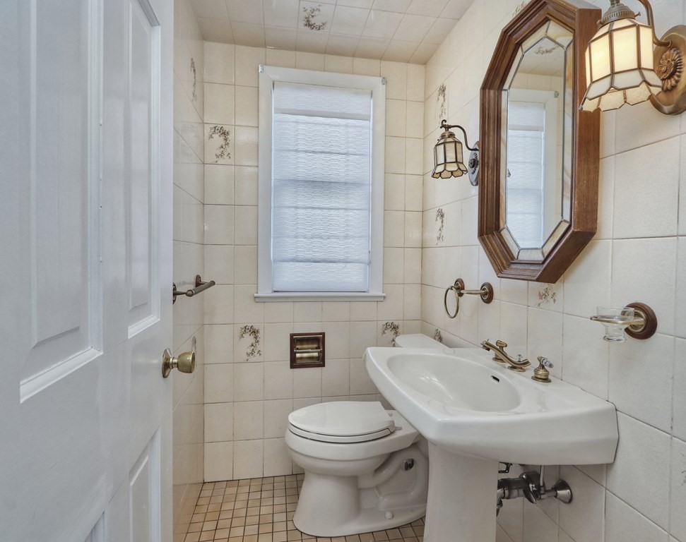 257 Lawrence Road Medford, MA 02155 - Photo 13 of 29 a bathroom with a sink a toilet and mirror