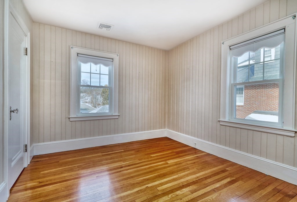 257 Lawrence Road Medford, MA 02155 - Photo 19 of 29 a view of an empty room with wooden floor and a window