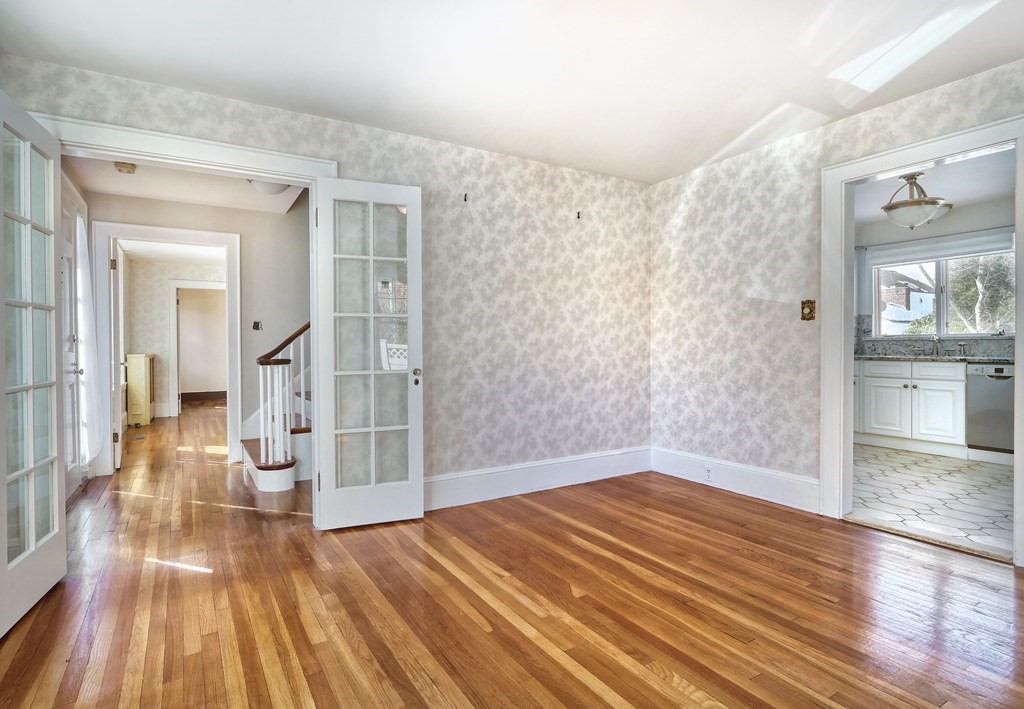 257 Lawrence Road Medford, MA 02155 - Photo 6 of 29 a view of a big room with wooden floor and a kitchen