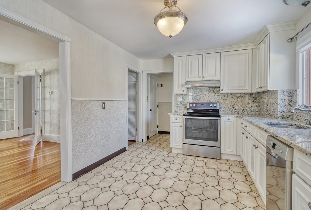 257 Lawrence Road Medford, MA 02155 - Photo 7 of 29 a kitchen with white cabinets and appliances