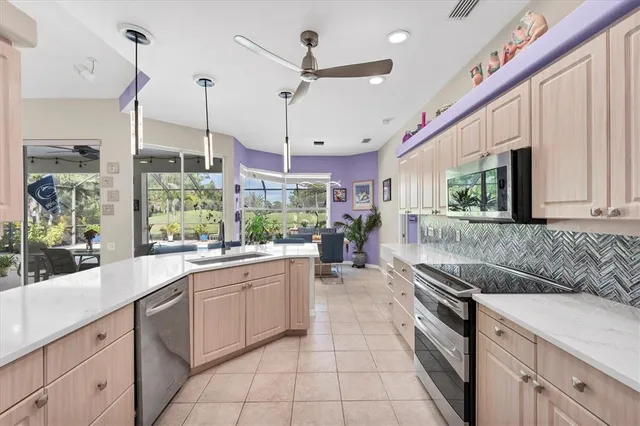 a kitchen with stainless steel appliances granite countertop a sink and cabinets