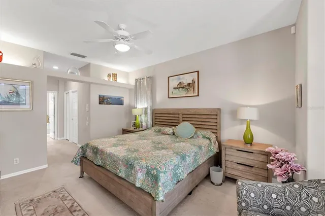 a bedroom with a bed and ceiling fan