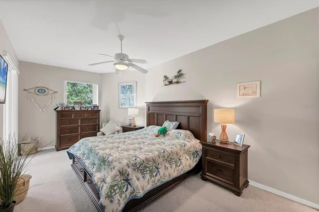 a bedroom with a large bed and a chandelier