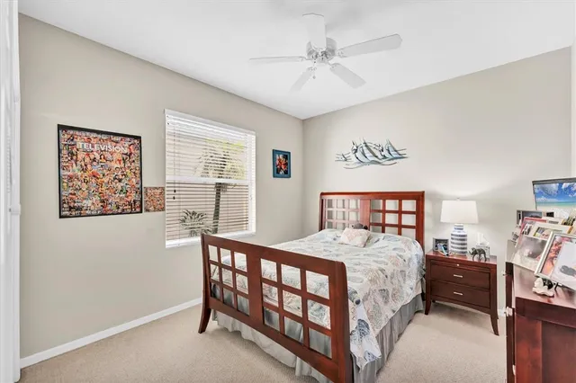 a bedroom with a bed a dresser next to a window