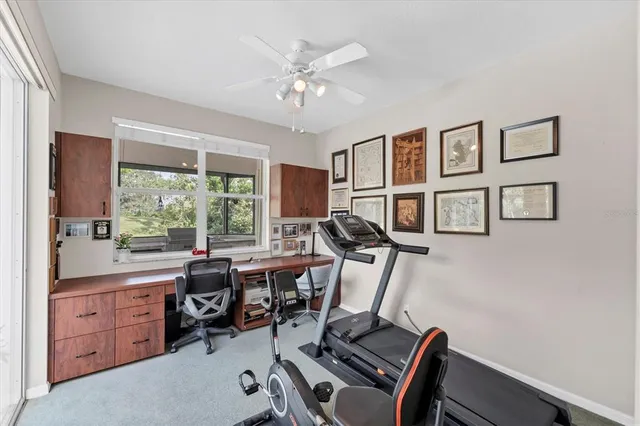 a view of a workspace with furniture and a window