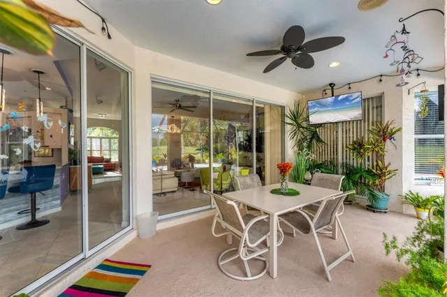 a dining room with furniture and potted plants