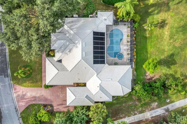 a aerial view of a house with swimming pool and garden