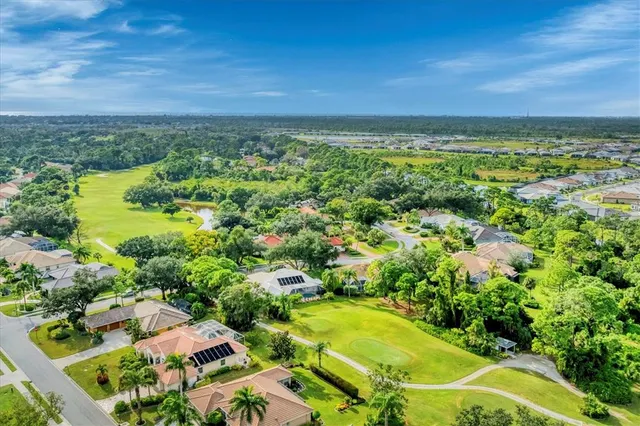 an aerial view of a house with yard swimming pool and outdoor seating