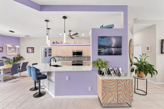 a living room with furniture potted plant and a flat screen tv