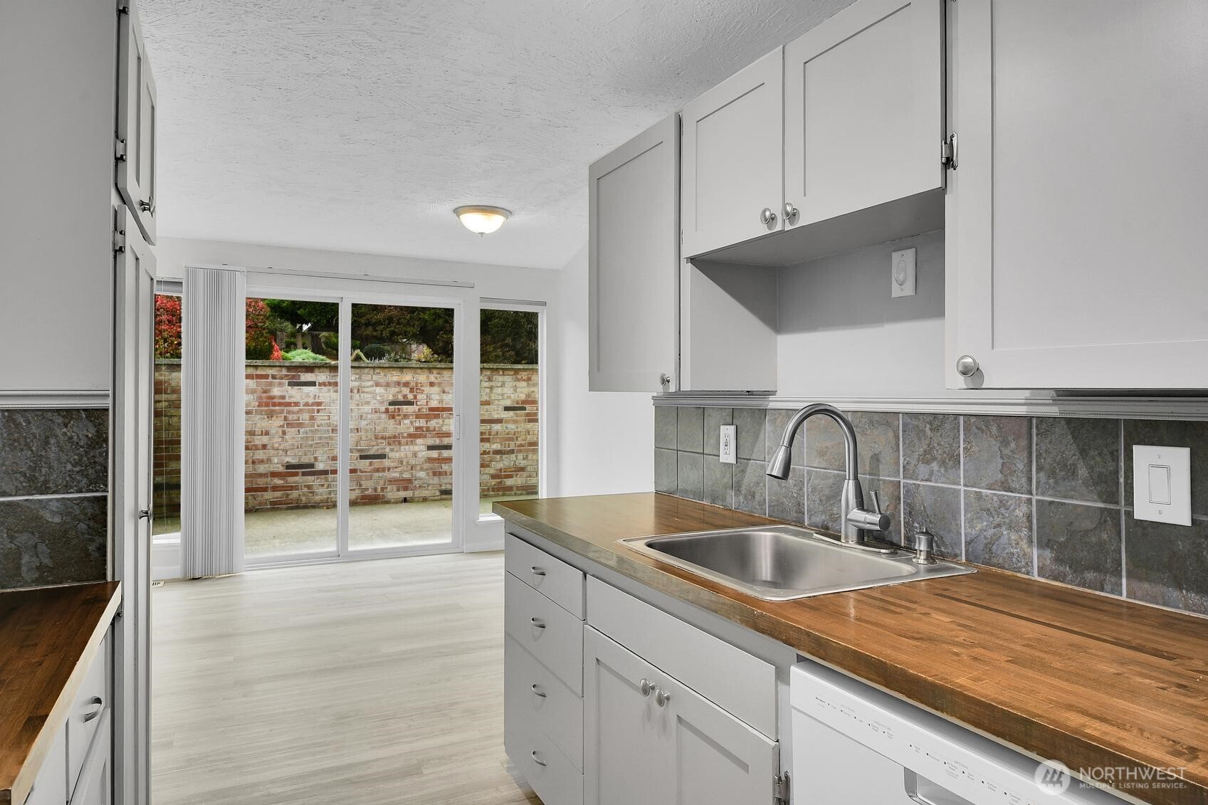 184 Southwest 200th Street Normandy Park, WA 98166 - Photo 11 of 20 a kitchen with stainless steel appliances a sink a stove and cabinets