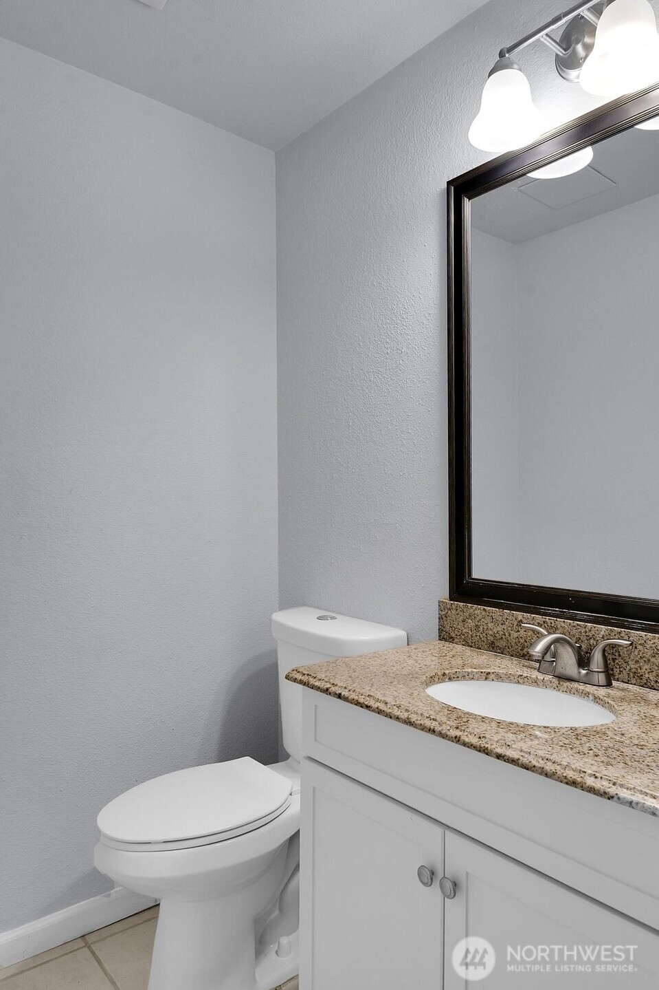 184 Southwest 200th Street Normandy Park, WA 98166 - Photo 18 of 20 a bathroom with a granite countertop toilet sink and mirror