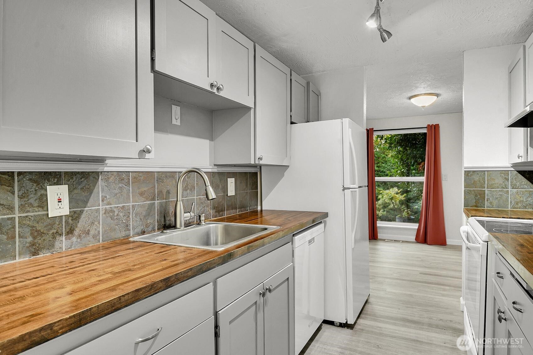 184 Southwest 200th Street Normandy Park, WA 98166 - Photo 8 of 20 a kitchen with stainless steel appliances granite countertop a sink and a refrigerator