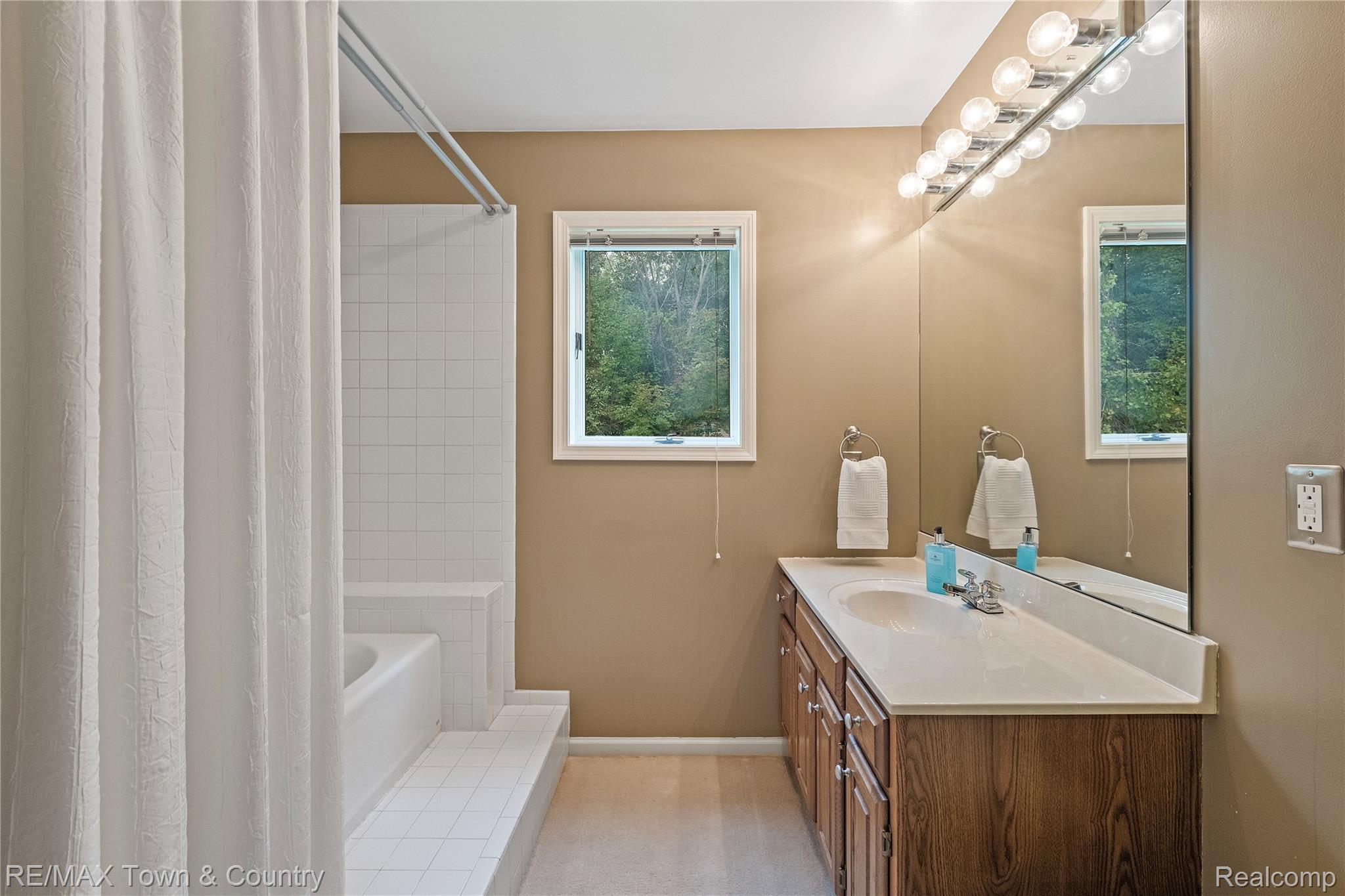 5464 North Seymour Road Flushing, MI 48433 - Photo 22 of 45 Wood-finish vanity with a white countertop and integrated sink