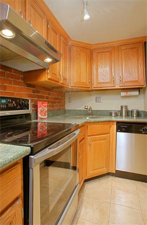 315 Beacon Street, Unit 5 Boston, MA 02116 - Photo 5 of 10 a kitchen with stainless steel appliances granite countertop a sink and a stove