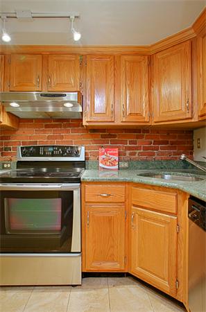 315 Beacon Street, Unit 5 Boston, MA 02116 - Photo 6 of 10 a kitchen with granite countertop cabinets stainless steel appliances and a sink