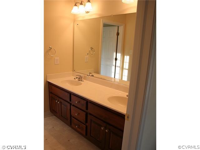 4 Winding Ridge Way Bumpass, VA 23024 - Photo 7 of 12 a bathroom with a double vanity sink and a mirror