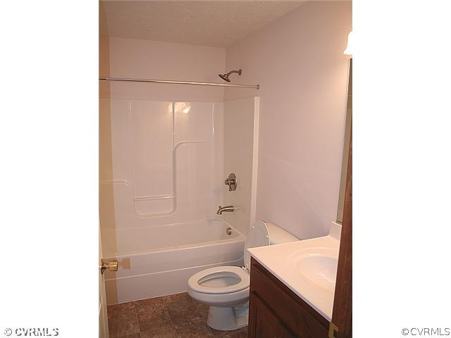 4 Winding Ridge Way Bumpass, VA 23024 - Photo 10 of 12 a bathroom with a granite countertop sink toilet and shower