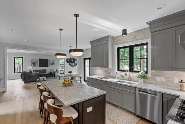 a kitchen with a table chairs and a wooden floor