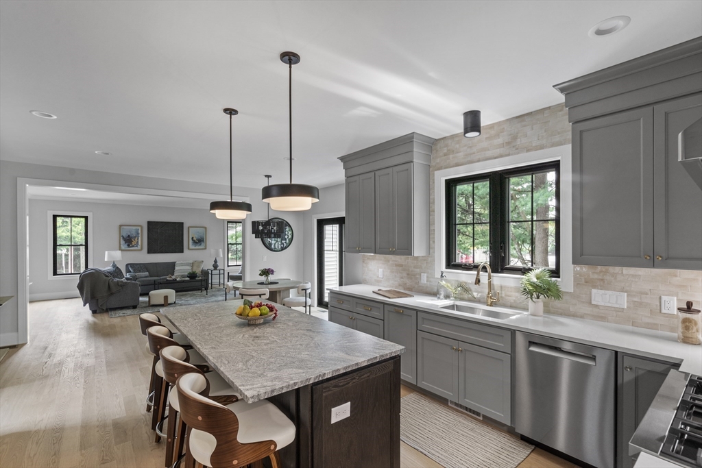 a kitchen with a table chairs and a wooden floor